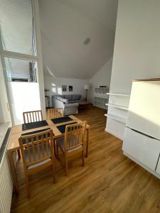 a kitchen with a table and chairs in a room at Ferienhaus Fam. Mersmann in Papenburg +6 photos