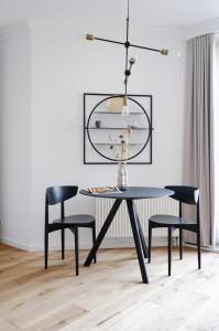 a dining room with a black table and chairs at R7 Berlin in Berlin