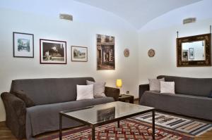 a living room with two couches and a coffee table at Minerva House in Rome