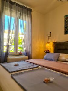 a bedroom with two beds and a window at Apartment TORRE - NEW in Senj