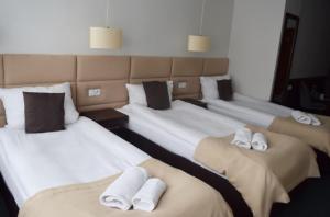 Posteľ alebo postele v izbe v ubytovaní Hotel Maraton