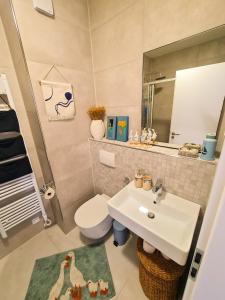 a bathroom with a sink and a toilet and a mirror at Apartment TORRE - NEW in Senj +82 photos