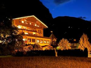 a large building is lit up at night at Resort Schrofenblick in Mayrhofen