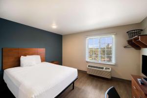 Ένα ή περισσότερα κρεβάτια σε δωμάτιο στο WoodSpring Suites Fort Worth Fossil Creek