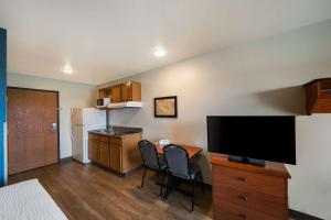 a small room with a kitchen and a television at WoodSpring Suites Fort Worth Fossil Creek in Fort Worth