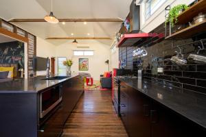 a kitchen with black cabinets and a long counter at Studio 22 Bellingen in Bellingen