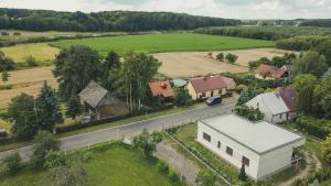 an aerial view of a village with a house and a road at Stara Kuźnia- Domek w Puszczy Noteckiej in Zatom Nowy