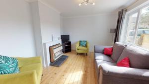 a living room with a couch and a fire place at Taphouse Avenue in Crawley