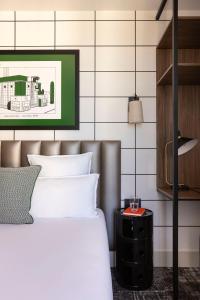 1 dormitorio con 1 cama y 1 mesa con lámpara en Hôtel Moderniste en París