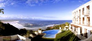 a view of the ocean from a building with a swimming pool at The Plettenberg Hotel in Plettenberg Bay