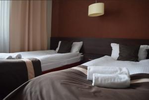 Posteľ alebo postele v izbe v ubytovaní Hotel Maraton