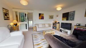 sala de estar con 2 sofás y TV en Thames View In Oxford en Oxford