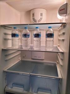 a refrigerator filled with lots of bottles of water at Piso Centro María Aire-Wifi in Elche