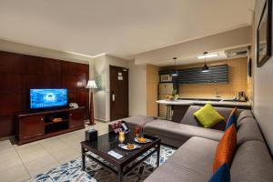 a living room with a couch and a kitchen at Boudl Abha in Abha