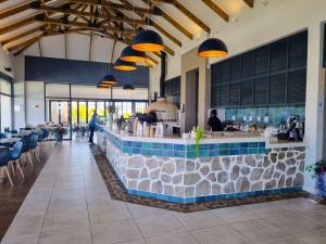 a bar in a restaurant with a stone counter at Hills Intweshe in Ballito