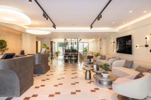 a lobby of a hospital with couches and tables at Erato by Samian Mare in Karlovasi