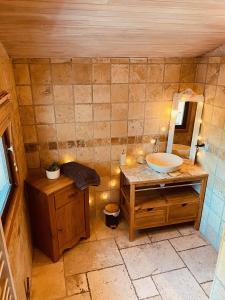 a bathroom with a sink and a mirror at Gite la maison du bonheur in Eygliers