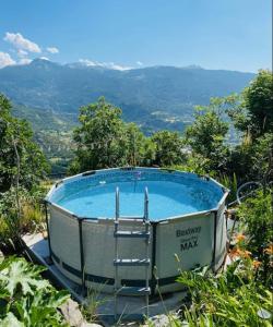 a jacuzzi tub sitting on top of a hill at Gite la maison du bonheur in Eygliers