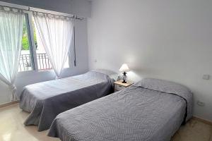 Postel nebo postele na pokoji v ubytování Hacienda Beach