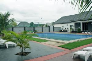 a swimming pool in front of a house at SILVERZB RESORT in Iseyin