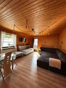 a large room with a bed and a couch at Tina a Petr , Lunz am See in Lunz am See