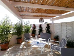 a patio with a table and chairs and potted plants at Casa Flora - Bed and Breakfast in Torre San Giovanni Ugento +26 photos