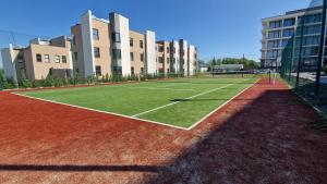 a tennis court in front of a building at Apartament pod Szyndzielnią in Bielsko-Biała