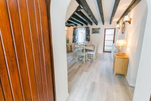 a room with a table and a dining room at Dinas Cottage in Benllech