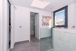 a white kitchen with a glass counter and a window at Beach Villa Cosins 1 Mel by Sealand Villas in Alcudia