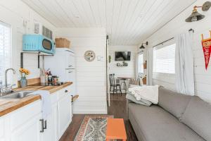 a kitchen and living room in a tiny house at Downtown Tiny Home near Shenandoah National Park in New Market