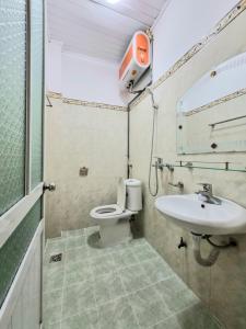 a bathroom with a toilet and a sink at Ha Giang Donkey hostel in Ha Giang