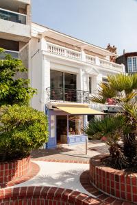 a white building with a balcony on top of it at VILLA Henry - FOCH in Les Sables-dʼOlonne