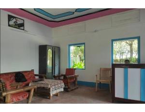 a living room with a coffered ceiling at Manas View Jungle Resort, Assam in Jyoti Gaon