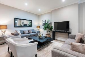 a living room with a couch and a tv at Hampstead Garden Flat-Hosted by Sweetstay in London