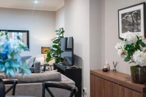 a living room with a couch and a tv at Hampstead Garden Flat-Hosted by Sweetstay in London