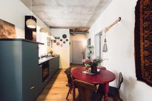 a kitchen with a wooden table in a room at Flecksches Gut in Leipzig