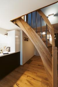 a staircase in a living room with wooden floors at Flecksches Gut in Leipzig