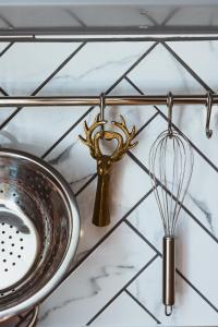 a kitchen counter with a whisk and a sink at Flecksches Gut in Leipzig +70 photos