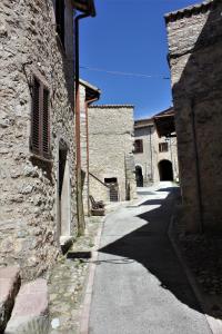 Meggiano的住宿－Il Rustico di Meggiano，两座石头建筑之间的小巷