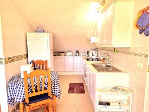 a small kitchen with a sink and a refrigerator at Luis Estudio Adeje Tenerife Sur by HRTenerife Net in Adeje