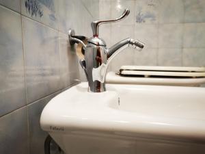 a bathroom sink with a faucet on top of a toilet at Dimora alla Villa in Ostuni +43 photos