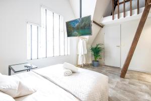 a white bedroom with a bed and a loft at New Family XL Utopia Top floor app4 Rotterdam-Schiedam City Centre Central in Schiedam