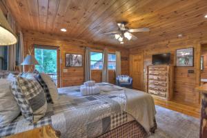 a bedroom with a bed and a ceiling fan at CaBEARnet Creek Cabin - hot tub, pet friendly, fire pit, outdoor fireplace in Morganton