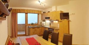 a kitchen with a table and a kitchen with a dining room at Ferienwohnung Natural A in Gerlosberg