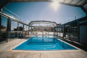 a large swimming pool inside of a building at Halykos Hotel in Cammarata