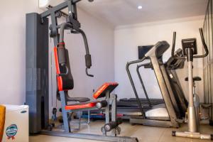 a gym with several exercise bikes and a treadmill at Suru Express Hotel GRA in Ikeja