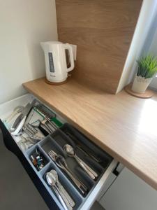 a drawer in a kitchen with a coffee maker on a counter at Widokówka in Toruń