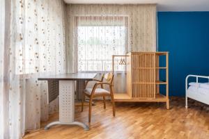 a room with a table and chairs and a window at Burov Apartment - artistic apartment in the heart of Varna suitable for up to 4 guests in Varna City