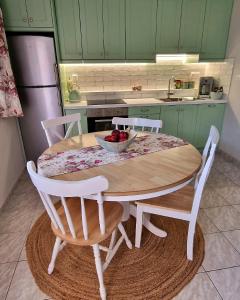 a kitchen with a table with a bowl of fruit on it at Primavera Apartment in Pilaroú