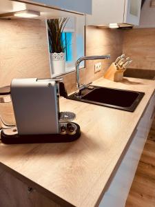 a kitchen with a laptop on a counter at Westend Amelander Kaap 85 in Hollum